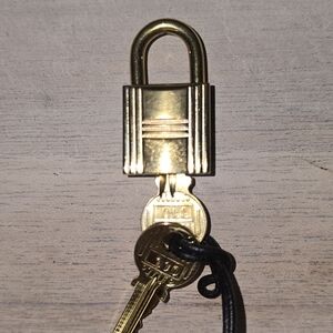 HERMES GOLD LOCK USED STAMPED  one lock and two keys #110 Authentic